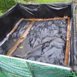 Mulch bin covered with black plastic.