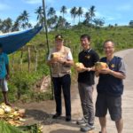 Rotarians Klaus, Casey and Hide (left to right) enjoying a refreshing coconut drink during a break in their hectic trip